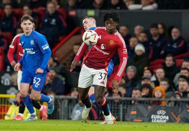 Manchester, England, 23rd January 2025. Kobbie Mainoo of Manchester United, ManU is challenged by Bailey Rice of Rangers during the UEFA Europa League match at Old Trafford, Manchester. Picture credit should read: Andrew Yates Sportimage EDITORIAL USE ONLY. No use with unauthorised audio, video, data, fixture lists, club league logos or live services. Online in-match use limited to 120 images, no video emulation. No use in betting, games or single club league player publications. SPI_032_AY_MAN_UTD_RANGERS SPI-3616-0032