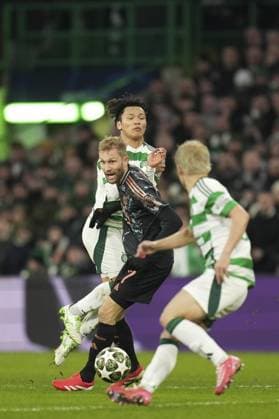 Konrad Laimer of Bayern Munich with the ball in between Reo Hatate of Celtic in background and Daizen Maeda of Celtic in foreground Celtic v Bayern Munich, UEFA Champions League, Knockout Round Play-offs, First Leg, Football, Celtic Park, Glasgow, UK - 12 Feb 2025 EDITORIAL USE ONLY No use with unauthorised audio, video, data, fixture lists, club league logos or live services. Online in-match use limited to 120 images, no video emulation. No use in betting, games or single club league player publications. Copyright: xStuartxWallace Shutterstockx 15136907cr