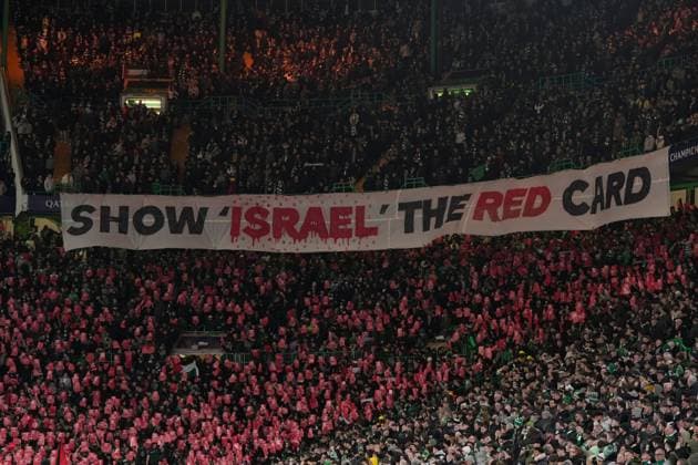 Celtic fans with banner reading: Show Israel the red card Celtic v Bayern Munich, UEFA Champions League, Knockout Round Play-offs, First Leg, Football, Celtic Park, Glasgow, UK - 12 Feb 2025 EDITORIAL USE ONLY No use with unauthorised audio, video, data, fixture lists, club league logos or live services. Online in-match use limited to 120 images, no video emulation. No use in betting, games or single club league player publications. Copyright: xStuartxWallace Shutterstockx 15136907dq