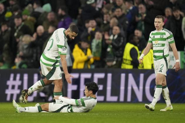 Cameron Carter-Vickers of Celtic picks dejected Hyunjun Yang of Celtic off the ground after final whistle, Alistair Johnston of Celtic (right) Celtic v Bayern Munich, UEFA Champions League, Knockout Round Play-offs, First Leg, Football, Celtic Park, Glasgow, UK - 12 Feb 2025 EDITORIAL USE ONLY No use with unauthorised audio, video, data, fixture lists, club league logos or live services. Online in-match use limited to 120 images, no video emulation. No use in betting, games or single club league player publications. Copyright: xStuartxWallace Shutterstockx 15136907ei