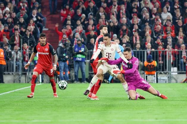 in duel, action, with Piero Hincapie 3 Bayer 04 Leverkusen , Mario Hermoso 5 Bayer 04 Leverkusen , Jamal Musiala 42 FC Bayern Muenchen , Matej Kovar 17 Bayer 04 Leverkusen , scores the goal for 2 0, FC Bayern Muenchen vs Bayer 04 Leverkusen, football, Champions League, round of 16, first leg, 05 03 2025 Muenchen Bayern Germany Copyright: xkolbert-press ChristianxKolbertx