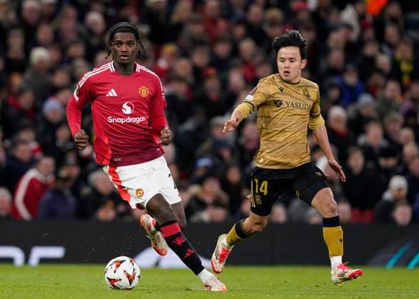 Manchester, England, 13th March 2025. Ayden Heaven of Manchester United, ManU and Takefusa Kubo of Real Sociedad during the UEFA Europa League match Manchester United v Real Sociedad at Old Trafford, Manchester. Picture credit should read: Andrew Yates Sportimage EDITORIAL USE ONLY. No use with unauthorised audio, video, data, fixture lists, club league logos or live services. Online in-match use limited to 120 images, no video emulation. No use in betting, games or single club league player publications. SPI_059_AY_MANU_SOCIEDAD SPI-3744-0062