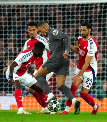 Kylian Mbappà of Real Madrid is surrounded by Thomas Partey, Mikel Merino and William Saliba of Arsenal Arsenal v Real Madrid, UEFA Champions League, Quarter Final, First Leg, Football, Emirates Stadium, London, UK - 08 Apr 2025 EDITORIAL USE ONLY No use with unauthorised audio, video, data, fixture lists, club league logos or live services. Online in-match use limited to 120 images, no video emulation. No use in betting, games or single club league player publications. Copyright: xJavierxGarcia Shutterstockx 15243595t