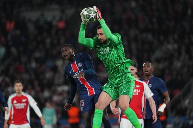 Gianluigi Donnarumma of PSG gathers under pressure from teammate Nuno Mendes of PSG Paris Saint-Germain v Arsenal, UEFA Champions League, Semi Final, Second Leg, Football, Parc des Princes, Paris, France - 07 May 2025 EDITORIAL USE ONLY No use with unauthorised audio, video, data, fixture lists, club league logos or live services. Online in-match use limited to 120 images, no video emulation. No use in betting, games or single club league player publications. Copyright: xDavexWinter Shutterstockx 15288067bk