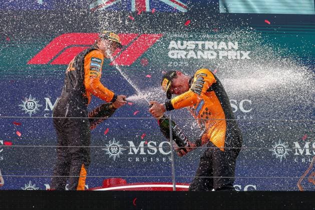 Champagne shower between the drivers, 2nd place Oscar Piastri McLaren Formula 1 Team , Winner, Winner, Lando Norris McLaren Formula 1 Team on the podium, Race, Grand Prix of Austria, Motorsport, Men, Formula 1, 29 06 2025 Spielberg Styria Austria Copyright: xkolbert-press ChristianxKolbertx