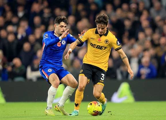 Hugo Bueno of Wolverhampton Wanderers in action against Pedro Neto of Chelsea Chelsea v Wolverhampton Wanderers, Premier League, Football, Stamford Bridge, London, UK - 08 Nov 2025London Stamford Bridge United Kingdom EDITORIAL USE ONLY No use with unauthorised audio, video, data, fixture lists, club league logos or live services. Online in-match use limited to 120 images, no video emulation. No use in betting, games or single club league player publications. Copyright: xGeorgexTewkesbury Shutterstockx 15702174an