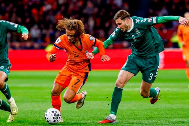 Xavi Simons of the Netherlands dribbles with the ball under pressure from Edgaras Utkus of Lithuania Netherlands v Lithuania, FIFA World Cup, WM, Weltmeisterschaft, Fussball 2026 Qualifier, Netherlands v Lithuania, Johan Cruijff Arena, November 17, 2025, Amsterdam, Netherlands.