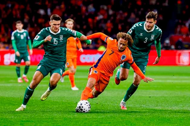 Xavi Simons of the Netherlands dribbles with the ball under pressure from Edgaras Utkus of Lithuania and Gvidas Gineitis of Lithuania Netherlands v Lithuania, FIFA World Cup, WM, Weltmeisterschaft, Fussball 2026 Qualifier, Netherlands v Lithuania, Johan Cruijff Arena, November 17, 2025, Amsterdam, Netherlands.