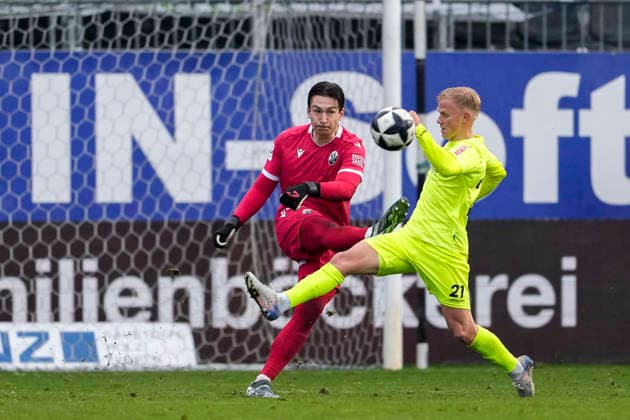 v li Lukas Schneller goalkeeper, SVS, 31 , Per Lockl Kickers, 21 , duel, duel, tackle, tackling, dynamics, action, action, in the penalty area, penalty area scene, 30 11 2025, Sandhausen Germany , Football, Regionalliga Südwest, SV Sandhausen SV Stuttgarter Kickers xozx