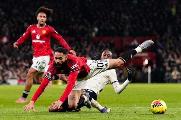 Manchester, England, 4th December 2025. Aaron Wan-Bissaka of West Ham United tackles Matheus Cunha of Manchester United, ManU during the Manchester United vs West Ham United Premier League match at Old Trafford, Manchester. Picture credit should read: Andrew Yates Sportimage EDITORIAL USE ONLY. No use with unauthorised audio, video, data, fixture lists, club league logos or live services. Online in-match use limited to 120 images, no video emulation. No use in betting, games or single club league player publications. SPI_030_AY_MANUTD_WESTHAM SPI-4345-0031