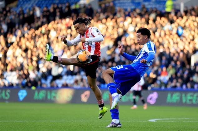 Yisa Alao of Sheffield Wednesday in action against Romelle Donovan of Brentford Sheffield Wednesday v Brentford, Emirates FA Cup, Third Round, Football, Hillsborough, Sheffield, UK - 10 Jan 2026Sheffield Hillsborough United Kingdom EDITORIAL USE ONLY No use with unauthorised audio, video, data, fixture lists, club league logos or live services. Online in-match use limited to 120 images, no video emulation. No use in betting, games or single club league player publications. Copyright: xGeorgexTewkesbury Shutterstockx 16246263ax