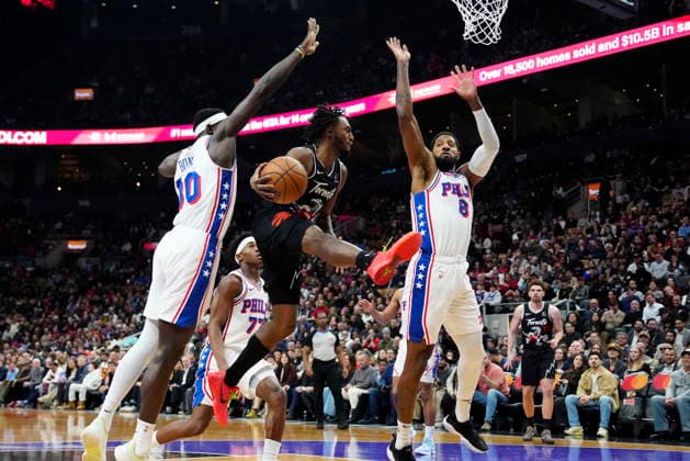 January 12, 2026, Toronto, On, CANADA: Toronto Raptors guard Immanuel Quickley (5) makes a pass under pressure from Philadelphia 76ers forward Adem Bona (30) and teammate Paul George (8) during first half NBA, Basketball Herren, USA basketball action in Toronto, Monday, Jan. 12, 2026. Canada News - January 12, 2026 - ZUMAc35_ 20260112_zaf_c35_072 Copyright: xFrankxGunnx
