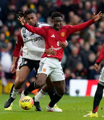 Manchester, England, 1st February 2026. Kobbie Mainoo of Manchester United, ManU (R) is challenged by Alex Iwobi of Fulham during the Manchester United vs Fulham Premier League match at Old Trafford, Manchester. Picture credit should read: Andrew Yates Sportimage EDITORIAL USE ONLY. No use with unauthorised audio, video, data, fixture lists, club league logos or live services. Online in-match use limited to 120 images, no video emulation. No use in betting, games or single club league player publications. SPI_066_AY_MAN_UTD_FULHAM SPI-4502-0065
