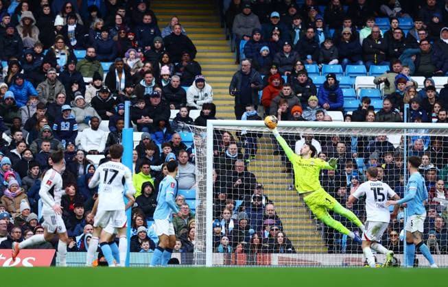 Manchester City goalkeeper James Trafford makes a save Manchester City v Salford City, Emirates FA Cup, Fourth Round, Football, Etihad Stadium, Manchester, UK - 14 Feb 2026Manchester Etihad Stadium United Kingdom EDITORIAL USE ONLY No use with unauthorised audio, video, data, fixture lists, club league logos or live services. Online in-match use limited to 120 images, no video emulation. No use in betting, games or single club league player publications. Copyright: xMattxWest Shutterstockx 16608276m