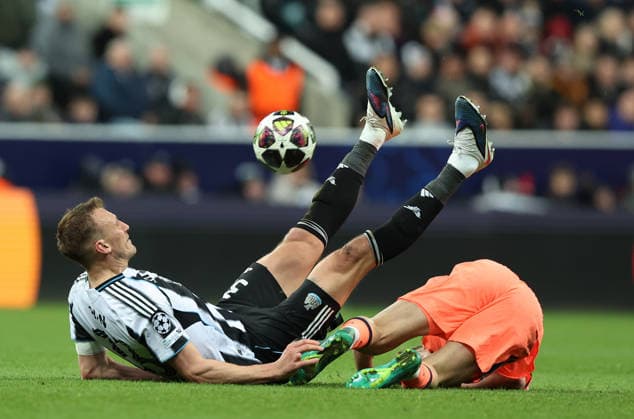 Newcastle Upon Tyne, England, 10th March 2026. Dan Burn of Newcastle United tackles Fermin Lopez of FC Barcelona, Barca during the Newcastle United vs FC Barcelona UEFA Champions League match at St. James Park, Newcastle Upon Tyne. Picture credit should read: Nigel Roddis Sportimage EDITORIAL USE ONLY. No use with unauthorised audio, video, data, fixture lists, club league logos or live services. Online in-match use limited to 120 images, no video emulation. No use in betting, games or single club league player publications. SPI_047_NR_NEWC_BARCx SPI-4596-0047