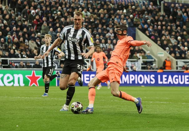 Newcastle Upon Tyne, England, 10th March 2026. Robert Lewandowski of FC Barcelona, Barca takes a shot as Dan Burn of Newcastle United closes in during the Newcastle United vs FC Barcelona UEFA Champions League match at St. James Park, Newcastle Upon Tyne. Picture credit should read: Nigel Roddis Sportimage EDITORIAL USE ONLY. No use with unauthorised audio, video, data, fixture lists, club league logos or live services. Online in-match use limited to 120 images, no video emulation. No use in betting, games or single club league player publications. SPI_049_NR_NEWC_BARCx SPI-4596-0049