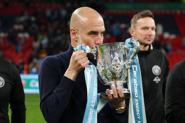 Manchester City manager Pep Guardiola holds the 2026 Carabao Cup trophy in front of the fans Arsenal v Manchester City, EFL Carabao Cup, Final, Football, Wembley Stadium, London, UK - 22 Mar 2026London Wembley Stadium United Kingdom EDITORIAL USE ONLY No use with unauthorised audio, video, data, fixture lists, club league logos or live services. Online in-match use limited to 120 images, no video emulation. No use in betting, games or single club league player publications. Copyright: xKieranxMcManus Shutterstockx 16783332mv