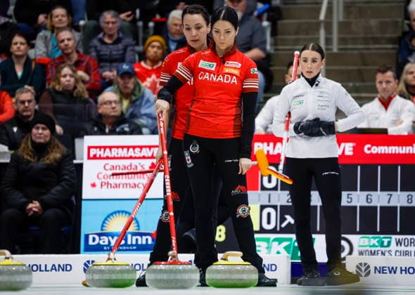 March 22, 2026, Calgary, Ab, CANADA: Team Canada skip Kerri Einarson, centre, and third Val Sweeting, left, discuss strategy as Switzerland s skip Xenia Schwaller looks on during the gold medal draw at the World Women™s Curling Championship in Calgary, Sunday, March 22, 2026. Val Sweeting, Kerri Einarson, Xenia Schwaller - ZUMAc35_ 20260322_zaf_c35_019 Copyright: xJeffxMcintoshx