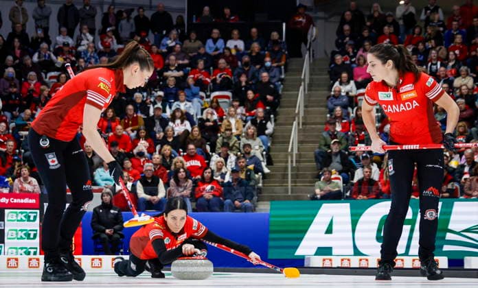 March 22, 2026, Calgary, Ab, CANADA: Team Canada skip Kerri Einarson, centre, delivers a stone against Switzerland as lead Karlee Burgess, left, and second Shannon Birchard sweep during the gold medal draw at the World Women™s Curling Championship in Calgary, Sunday, March 22, 2026. Karlee Burgess, Shannon Birchard, Kerri Einarson - ZUMAc35_ 20260322_zaf_c35_020 Copyright: xJeffxMcintoshx