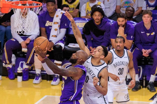 March 27, 2026, Los Angeles, California, USA: LeBron James 23 of the Los Angeles Lakers puts up a layup past Josh Binott 00 of the Brooklyn Nets during a regular season NBA, Basketball Herren, USA game on Friday March 27, 2026 at Crypto.com Arena in Los Angeles, California. Lakers defeat Nets, 116-99. JAVIER ROJAS PI Lakers Defeat Nets, 116-99 - ZUMAp124 20260327_zaa_p124_065 Copyright: xJavierxRojasx