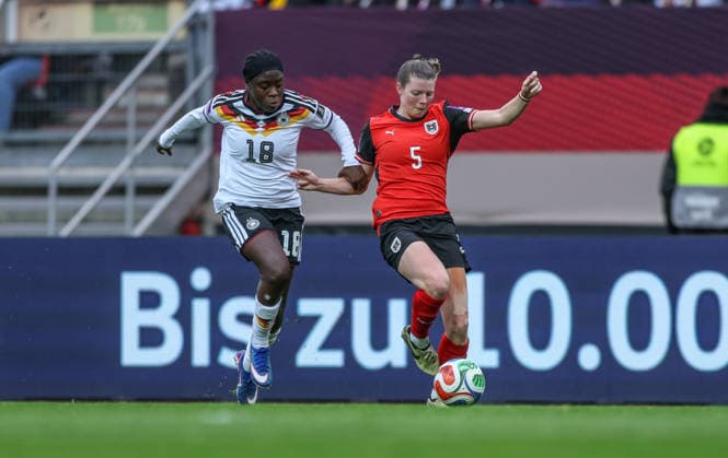 GER, Nuremberg, Germany vs Austria, International match, Football, FIFA, 2026 2027 season, World Cup Qualification, Max Morlock Stadium, 3 Matchday in picture from l Nicole Anyomi Germany Women 18 , Claudia Wenger Austria 5 DFB DFL REGULATIONS PROHIBIT ANY USE OF PHOTOGRAPHS AS IMAGE SEQUENCES AND OR QUASI VIDEO, 14 04 2026 Copyright: HMBxMedia HendrikxHamelau