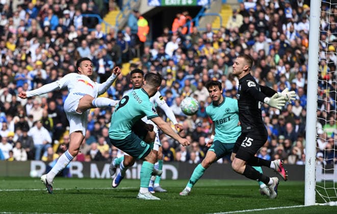 Goalkeeper Daniel Bentley of Wolverhampton Wanderers saves at point blank range from Ethan Ampadu of Leeds United Leeds United v Wolverhampton Wanderers, Premier League, Football, Elland Road, Leeds, UK - 18 Apr 2026Leeds Elland Road United Kingdom EDITORIAL USE ONLY No use with unauthorised audio, video, data, fixture lists, club league logos or live services. Online in-match use limited to 120 images, no video emulation. No use in betting, games or single club league player publications. Copyright: xGreigxCowie Shutterstockx 16832140ad
