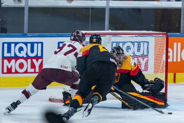 ZURICH, SWITZERLAND - MAY 17: Kai Wissmann (Germany, 6) in a duel against Haralds Egle (Latvia, 97) in the front of Philipp Grubauer (Germany, 30) goal during the Preliminary Round - Group A Match 15 between Germany and Latvia at the IIHF Ice hockey, Eishockey World Championship, WM, Weltmeisterschaft 2026, Swiss Life Arena on May 17, 2026 in Zurich, Switzerland. Zurich Switzerland Copyright: xTimoxSteinx