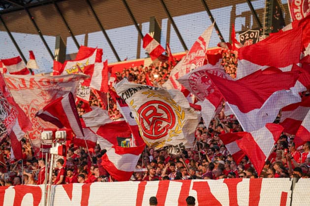 Germany Football 2 Bundesliga Relegation 2025 2026 Rot Weiss Essen vs SpVgg Greuther Fürth Stadion an der Hafenstraße Essen Home fans of Rot Weiss Essen create an impressive atmosphere in the stands with numerous red and white flags and banners during the relegation match Dense fan curve in the evening light with active choreography and emotional support for the team Ultras, Supporters, soccer culture, Ruhr region, traditional club, home block, sea of flags, spectators, promotion fight, 2 Bundesliga, stadium atmosphere, matchday, emotions, passion for soccer, sporting event, North Rhine-Westphalia, STEINSIEK CH Copyright: xJOERANxSTEINSIEKx