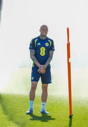 Lyndon Dykes of Scotland cools down under a sprinkler during a training session on a hot afternoon at Lesser Hampden. Scotland Team Training, Football, Hampden Park, Glasgow, Scotland, UK - 26 May 2026Glasgow Hampden Park United Kingdom EDITORIAL USE ONLY No use with unauthorised audio, video, data, fixture lists, club league logos or live services. Online in-match use limited to 120 images, no video emulation. No use in betting, games or single club league player publications. Copyright: xStuartxWallace Shutterstockx 16898315b