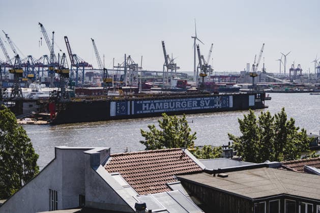 Germany, Hamburg, Port of Hamburg, Blohm Voss Dock 11, Dock 11, floating dock, Hamburger SV, HSV, HSV advertising, member advertising, HSV banner, HSV scarf, soccer culture, traditional club, promotion campaign, Raute Dich de, From the Elbe to the Isar always HSV, Port of Hamburg, Elbe, harbor cranes, container terminal, shipyard, shipyard industry, shipyard, dock facility, maritime scene, Industrial port, port panorama, port operations, shipping, water traffic, container port, port photography, maritime photography, urban photography, northern Germany, city view, industrial architecture, docklands, Elbe view, morning light, sunlight, summer light, Hamburg skyline, port industry, large shipyard, banner advertising, outdoor advertising, logistics, container logistics, wind turbines Copyright: xStefanxTrochax
