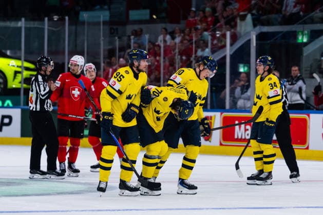 ZURICH, SWITZERLAND - MAY 28: Jacob de la Rose (Sweden, 95) and Simon Holmstrom (Sweden, 10) bringing the hitter Oskar Sundqvist (Sweden, 70) of the Ice during the Quarter Finals - Match 59 between Switzerland and Sweden at the IIHF Ice hockey, Eishockey World Championship, WM, Weltmeisterschaft 2026, Swiss Life Arena on May 28, 2026 in Zurich, Switzerland. Zurich Switzerland Copyright: xTimoxSteinx