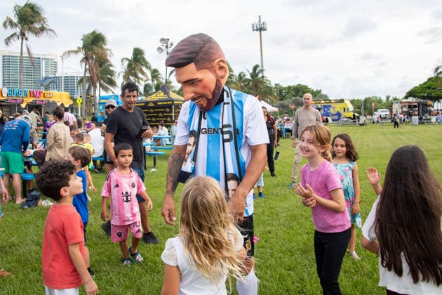 MIAMI, FL - JUNE 09: A person dressed to look like Lionel Messi wearing an Argentina national team, Nationalteam jersey interacts with event attendees on June 9, 2026 at Haulover Park, in Miami, FL. The Food Trucks Tuesdays event at Haulover Park is a weekly free admission community event featuring local food vendors, family-friendly activities, music, and kite flying. Recent events include Panini FIFA World Cup, WM, Weltmeisterschaft, Fussball 2026 Sticker trading, with a goal of helping collectors fill their albums. The performer dressed like Lionel Messi was introduced to attendees as a surprise guest visiting ahead of the 2026 FIFA World Cup. (Photo by Erica Denhoff Icon Sportswire) SOCCER: JUN 09 Food Trucks Tuesdays at Haulover Park EDITORIAL USE ONLY Icon260911