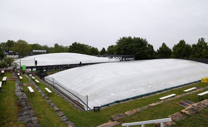 BAU 10 06 2026, Germany, Stuttgart, tennis, BOSS Open 2026, rain, rain feature, feature, empty courts, grass cover, cover, overview, person with umbrella, umbrella