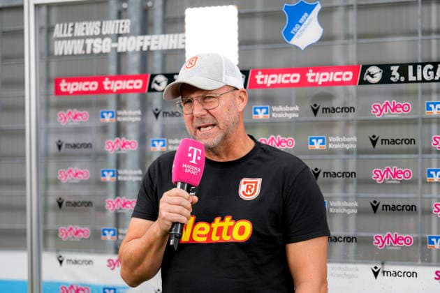 Sascha Hildmann, Coach, Head Coach, Regensburg, holding a microphone during an interview with Magenta Sport (magentaSport), TV, television, still image, single photo, August 29, 2026, Sinsheim, Germany, soccer, 3. Liga, TSG 1899 Hoffenheim II vs. SSV Jahn Regensburg; DFB and DFL regulations prohibit any use of photographs as image sequences and or quasi-video xozx