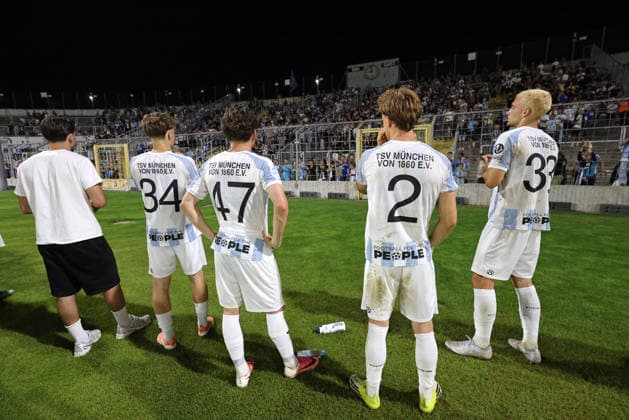 Soccer, Men s, Toto Cup, Quarterfinals, 2026–2027 Season, TSV 1860 Munich vs. TSV Buchbach, Grünwalder Stadium. The players of TSV 1860 Munich are with the fans in front of the West Stand after the game, taking a lap of honor. Pictured here are Edon Krasniqi (TSV 1860 Munich), Lance Fiedler (TSV 1860 Munich), Julian Bell of TSV 1860 Munich, and Lasse Fassmann of TSV 1860 Munich