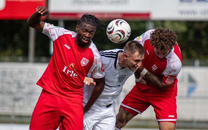 Soccer, 2026–2027 Season, Regionalliga West, September 5, 2026, Matchday 7, Men’s, 1 FC Bocholt (White) vs. Sportfreunde Siegen (Red); from left: Matono Glody Ngyombo (SF Siegen), Alexander Hahn (1 FC Bocholt), Jan Luca Rumpf (SF Siegen); Bocholt Stadion am Huenting, Germany 260905_fb_1fc-bocholt_sf-siegen_58414