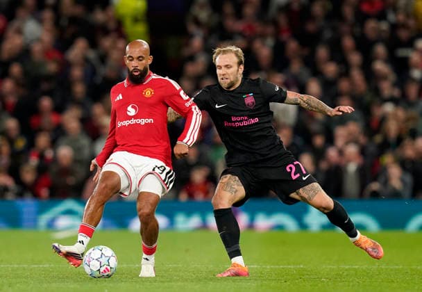 Manchester, England, 10th September 2026. Bryan Mbeumo of Manchester United, ManU tussles with Tymoteusz Puchacz of Sabah FC during the Manchester United vs Sabah UEFA Champions League match at Old Trafford, Manchester. Picture credit should read: Andrew Yates Sportimage EDITORIAL USE ONLY. No use with unauthorised audio, video, data, fixture lists, club league logos or live services. Online in-match use limited to 120 images, no video emulation. No use in betting, games or single club league player publications. SPI_051_AY_Man_Utd_Sabah SPI-4989-0051