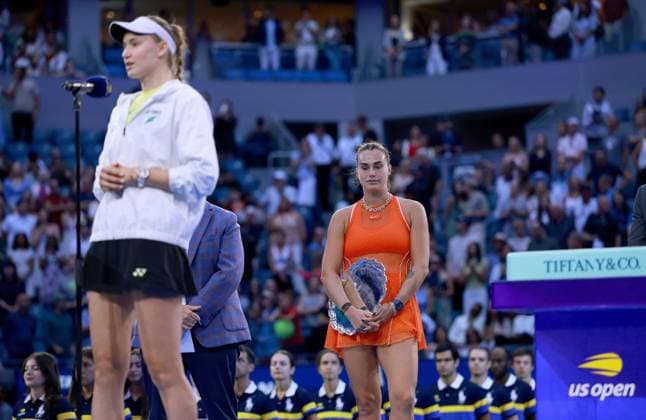 Aryna Sabalenka of Belarus frustrated stands behind Elena Rybakina with he trophy 2026 US Open, Day Fourteen, USTA Billie Jean King National Tennis Center, New York, USA - 12 Sep 2026New York USTA Billie Jean King National T New York (NY) United States of America EDITORIAL USE ONLY No use with unauthorised audio, video, data, fixture lists, club league logos or live services. Online in-match use limited to 120 images, no video emulation. No use in betting, games or single club league player publications. Copyright: xEllaxLing Shutterstockx 17140165bz
