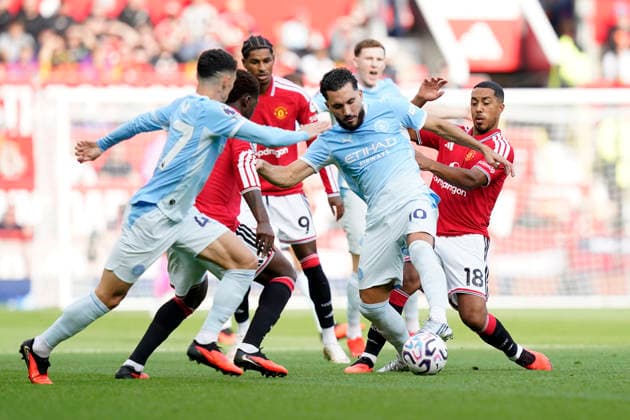 Manchester, England, 13th September 2026. Youri Tielemans of Manchester United, ManU with Rayan Cherki of Manchester City during the Manchester United vs Manchester City Premier League match at Old Trafford, Manchester. Picture credit should read: Andrew Yates Sportimage EDITORIAL USE ONLY. No use with unauthorised audio, video, data, fixture lists, club league logos or live services. Online in-match use limited to 120 images, no video emulation. No use in betting, games or single club league player publications. SPI_020_AY_MAN_UTD_MAN_CITY SPI-4993-0021