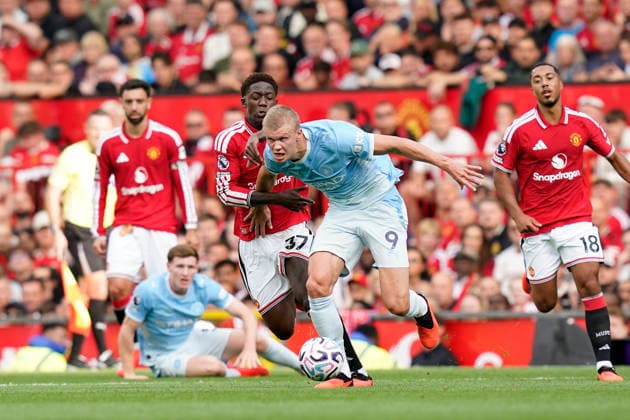 Manchester, England, 13th September 2026. Kobbie Mainoo of Manchester United, ManU with Erling Haaland of Manchester City during the Manchester United vs Manchester City Premier League match at Old Trafford, Manchester. Picture credit should read: Andrew Yates Sportimage EDITORIAL USE ONLY. No use with unauthorised audio, video, data, fixture lists, club league logos or live services. Online in-match use limited to 120 images, no video emulation. No use in betting, games or single club league player publications. SPI_048_AY_MAN_UTD_MAN_CITY SPI-4993-0040