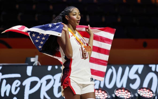 Aliyah Boston poses with her gold medal and the U.S. flag, celebrating Team USA s World Championship victory. Joy, Emotion, Sports, Basketball, FIBA World Cup, World Championship, Women s World Championship, World Championship Final, 2026-2027 Season, September 13, 2026, France vs. USA