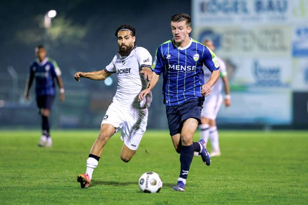 September 18, 2026, xkwix, Soccer, Regionalliga West, SV Rödinghausen vs. FC Gütersloh, Häcker Wiehenstadion, Matchday 9, 2026–2027 season: Aleksandar Kandic of FC Gütersloh 27 in a tackle against Mika Polat of SV Rödinghausen 8. DFB regulations prohibit any use of photographs as image sequences and or quasi-video. Photo: xKamilxWilkowskixPressefotoKochx, North Rhine-Westphalia, Germany