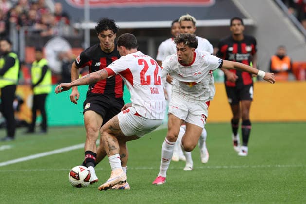 Ibrahim Maza of Bayer 04 Leverkusen, David Raum of RB Leipzig, and Neil El Aynaoui of RB Leipzig in a tackle during the Bundesliga 1 match between Bayer 04 Leverkusen and RB Leipzig, BayArena on September 20, 2026, in Leverkusen, Germany. Photo by Oliver Kaelke, DeFodi Images. Ibrahim Maza of Bayer 04 Leverkusen, David Raum of RB Leipzig and Neil El Aynaoui of RB Leipzig battle for the ball during the Bundesliga match between Bayer 04 Leverkusen and RB Leipzig at BayArena on September 20, 2026 in Leverkusen, Germany. Photo by Oliver Kaelke, DeFodi Images. DFB and DFL regulations prohibit any use of photographs as image sequences and or quasi-video. Photo by Oliver Kaelke, DeFodi Images.