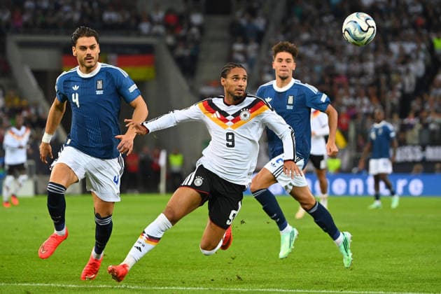 From left: Ntinos MAVROPANOS (Greece), Kevin SCHADE (GER), Giorgiow VAGIANNIDIS (Greece), Action, Tackle, Soccer Nations League Group Stage, Group B, Matchday 2: Germany (GER) vs. Greece (GRE) 0–1, on September 27, 2026, at WWK Arena Augsburg