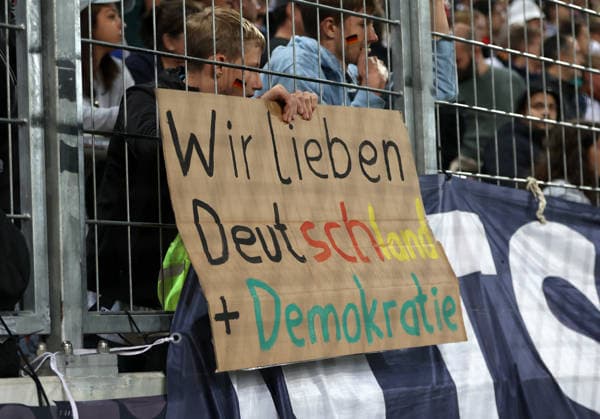 Germany vs. Greece, Soccer, Men s, 2026–2027 Season, International Match, Nations League, Matchday 2, League A, Group 2, WWK Arena A fan holding a cardboard sign that reads, We Love Germany and Democracy