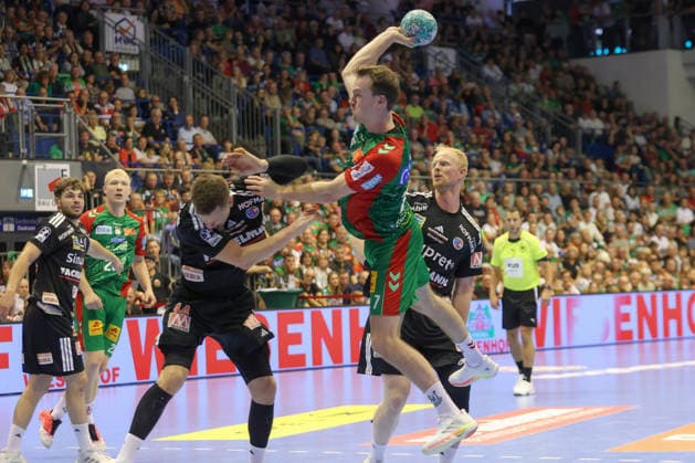 October 4, 2026, xtgx, Opel HBL handball, SC Magdeburg vs. HC Erlangen emspor, from left: Christopher Steinert (Erlangen), 44, Felix Claar (Magdeburg), 7, duel, battle, tackle, scores a goal, goal scorer, scores the goal, Magdeburg