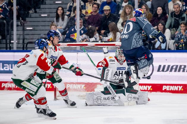 Elis Hede of EHC Red Bull Munich jumps 10 in front of Tobias Ancicka, goaltender for the Augsburger Panther, 45, to clear the way for the puck toward the goal GER, EHC Red Bull Munich vs. Augsburger Panther, DEL, 2026–2027 season, Matchday 6, October 4, 2026. Photo: HMB Media, Heike Feiner Copyright: HMBxMedia HeikexFeiner