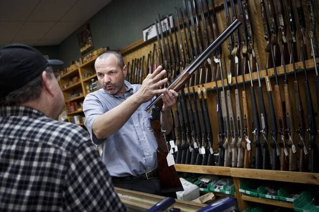 Feb. 19, 2013 - Redding, CA, USA - Redding Vice mayor and the owner of a gun shop Patrick Jones, right, shows a customer, John Robinson of Redding a shotgun in his store, February 19, 2013. Shasta County has the highest per-capita rate of gun background checks, indicating attempts to buy firearms, of any county in California, which has some of the nation s strictest gun laws. - ZUMAgun