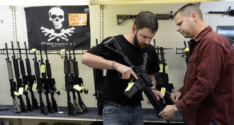 Dec. 18, 2012 - Wendell, NC, USA - Sales representative Jason Brown, left, shows Steve Levy, of Rolesville, North Carolina, an AR-15 assault rifle manufactured by Core15 Rifle Systems at Perry s Gun Shop in Wendell, N.C., on Tuesday, December 17, 2012. The weapon costs $2,384 and features an EoTech optical sighting system and a 30-round magazine capacity. - ZUMAm67_