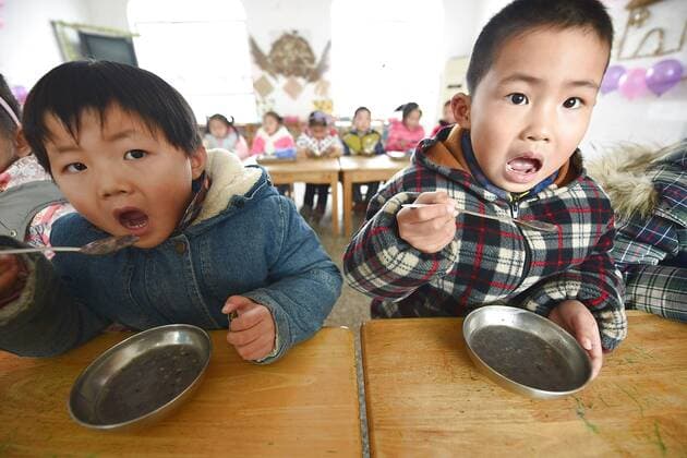 January 4, 2017 - Lianyungang, Lianyungang, China - Lianyungang, CHINA-January 4 2017: (EDITORIAL USE ONLY. CHINA OUT)..Pupils enjoy the Laba rice porridge at a primary school in Donghai County, Lianyungang City,east China s Jiangsu Province, January 4th, 2017, celebrating the Laba Rice Porridge Festival which falls on January 5th this year. The Laba Rice Porridge Festival is a traditional Chinese festival falls on the 8th day of the 12th month of lunar calendar. It s customary on this day to drink the special porridge, usually stewed of at least eight ingredients. With rice as the main ingredient, this porridge may well contain ingredients like broad beans, red beans, mung beans, red dates, peanuts, chest nuts, both tasty and nutritious. Lianyungang China - ZUMAs145 20170104_zaa_s145_193